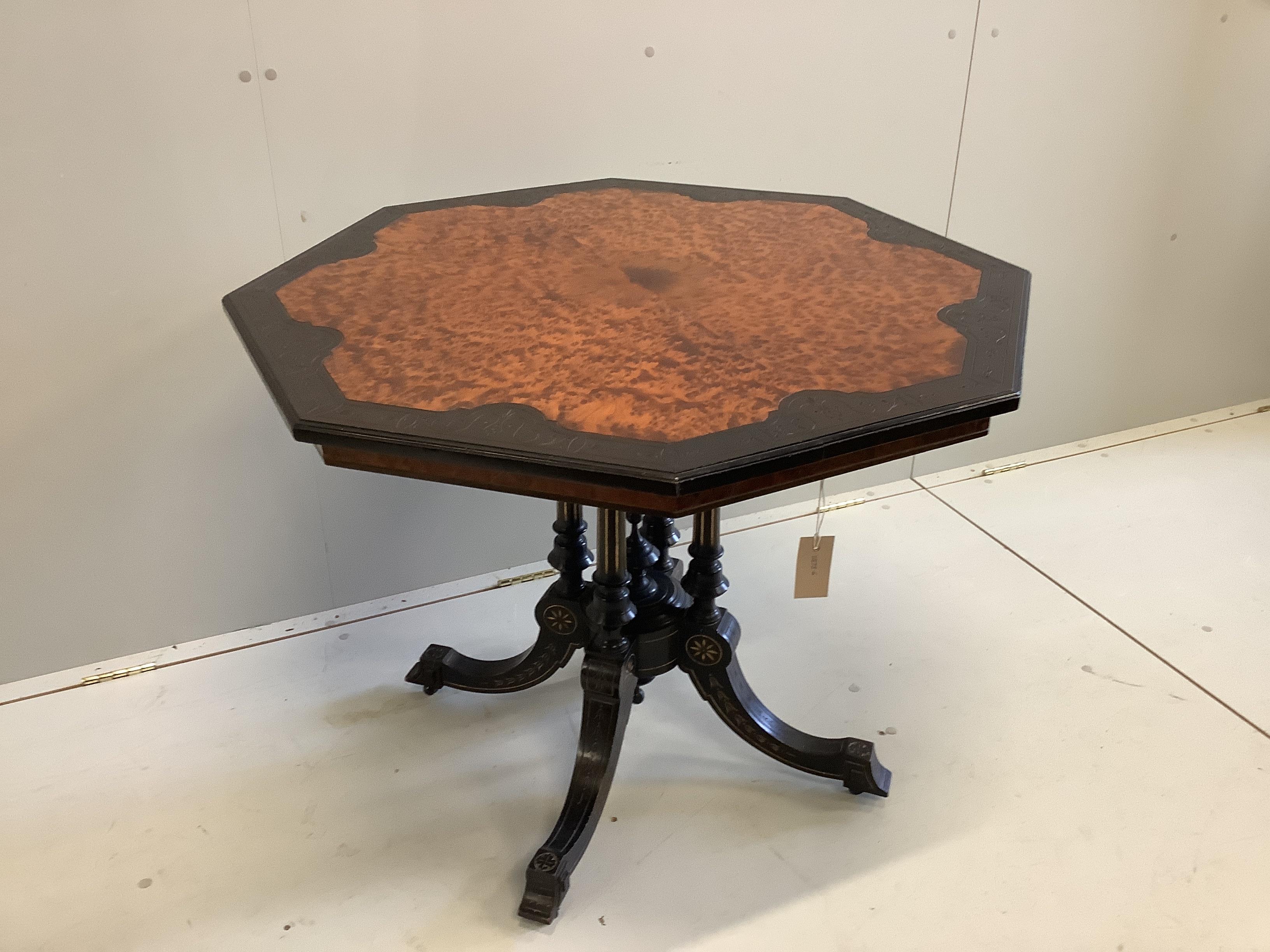 A late Victorian ebonised and amboyna octagonal centre table, width 89cm, height 71cm